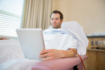 Patient Using Tablet Computer During Renal Dialysis