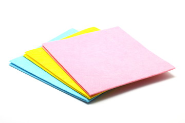Multi colored cleaning cloths isolated on white background