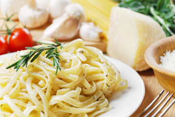 Pasta in the white plate on the wooden table
