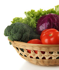 Different vegetables in basket isolated on white