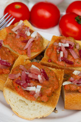 bread with tomatoes and jamon close up