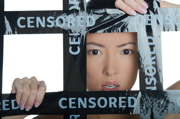 Frightened asian in a cage