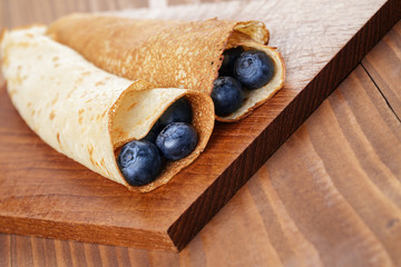homemade blinis or crepes with blueberries