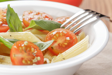simple italian pasta penne with tomatoes and basil