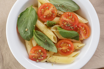 simple italian pasta penne with tomatoes and basil