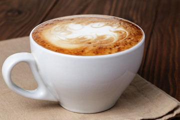 freshly made cup of cappuccino with abstract latte art