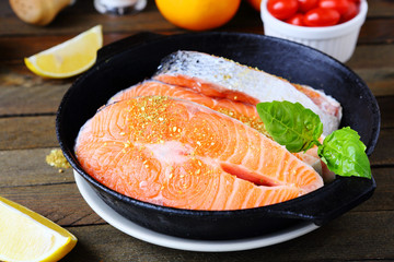 raw salmon fish fillets in the pan