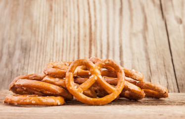 Salted pretzel snacks on the old wooden background
