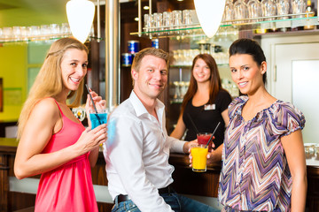 Young people with cocktails in bar