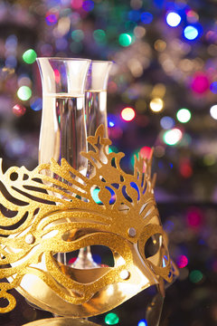Two glasses of champagne and venetian mask