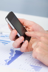 Person's Hand Using Cell Phone