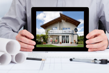 Architect Showing Picture Of House