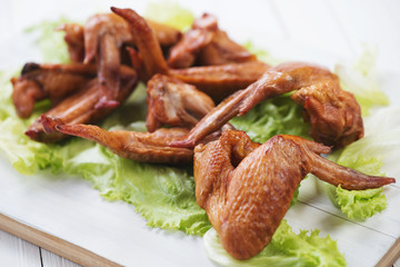 Smoked chicken wings and green salad, horizontal shot