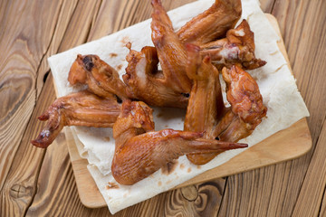 Above view of smoked chicken wings on pita bread