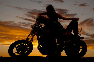 Fototapeta na wymiar silhouette man lay back on motorcycle woman over him