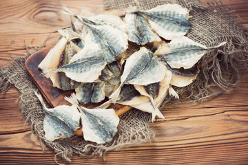 Dried scad on a rustic wooden table, above view
