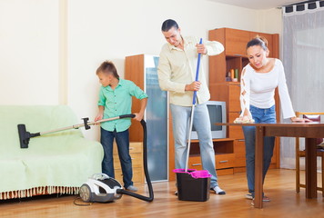 Family cleaning in living room