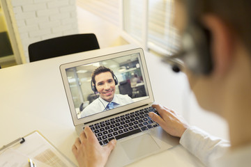 Businessman in the office on videoconference with headset, Skype