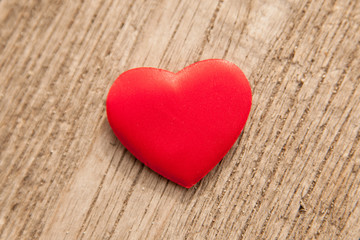 red heart over a wooden background