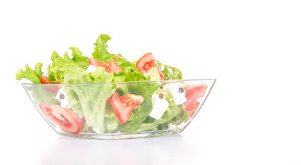 Mixed salat in a glass bowl isolated on white