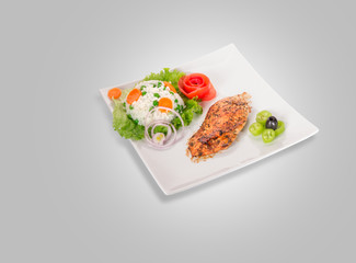 Chicken fillet on plate isolated on gray