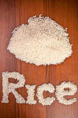 word of rice grains on a wooden background