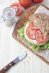 Fresh vegan sandwich with garbanzo beans, tomato and salad