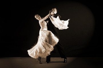 Latino dancers in ballroom isolated on black