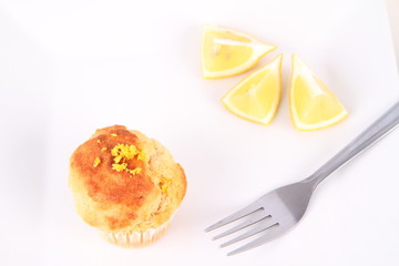 Lemon muffin and lemon pieces on a plate