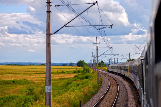 Fototapeta Passenger train on the railway in summer day.
