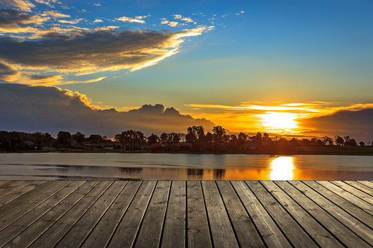 Empty wooden pier at sunset a beautiful colorful morning.