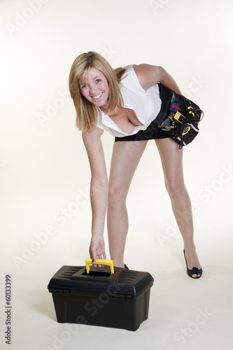 Woman wearing short skirt and long legs with toolbox