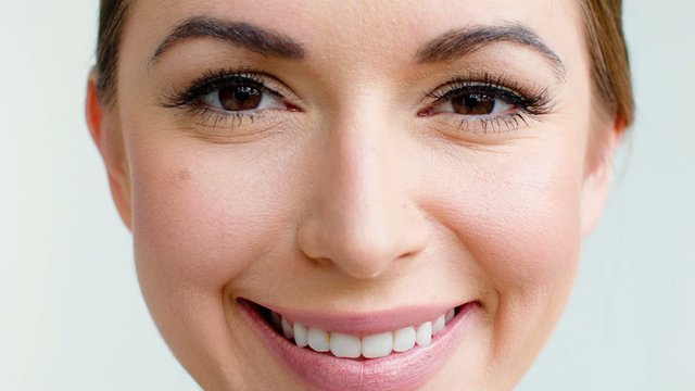 Close up Portrait of Smiling Girl Looking into Camera