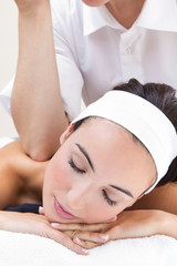 Obraz na płótnie Canvas Woman enjoying shoulder massage at beauty spa