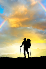 Silhouette of a tourist on the mountain top