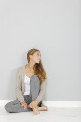 Woman sat leaning against wall
