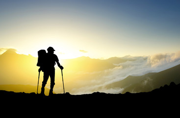 Silhouette of a tourist on the mountain top