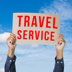 Man hand holding paper with travel service word