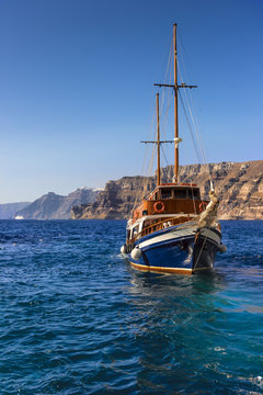 sailing ship on a background picturesque rocky shore