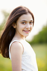 Portrait Of Smiling Hispanic Girl In Countryside
