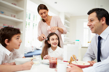 Family Having Breakfast Before Husband Goes To Work