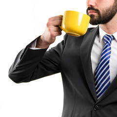 Young businessman drinking a coffee over white background