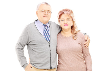 Middle aged couple in a hug looking at camera