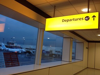 Departure sign in an airport with plane in the background - 60152301
