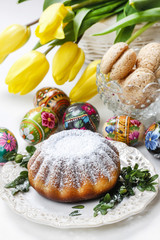 Easter cake and bouquet of yellow tulips on the table