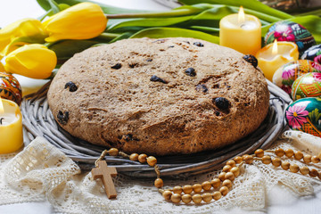 Festive easter bread and bouquet of beautiful yellow tulips