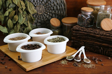 Fototapeta na wymiar Assortment of spices in white spoons and bowls,