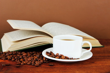 Cup of coffee with coffee beans and book