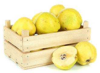 Sweet quinces in wooden box isolated on white