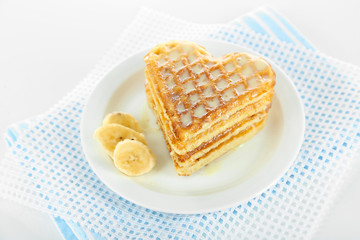 Sweet Belgium waffles with banana, isolated on white